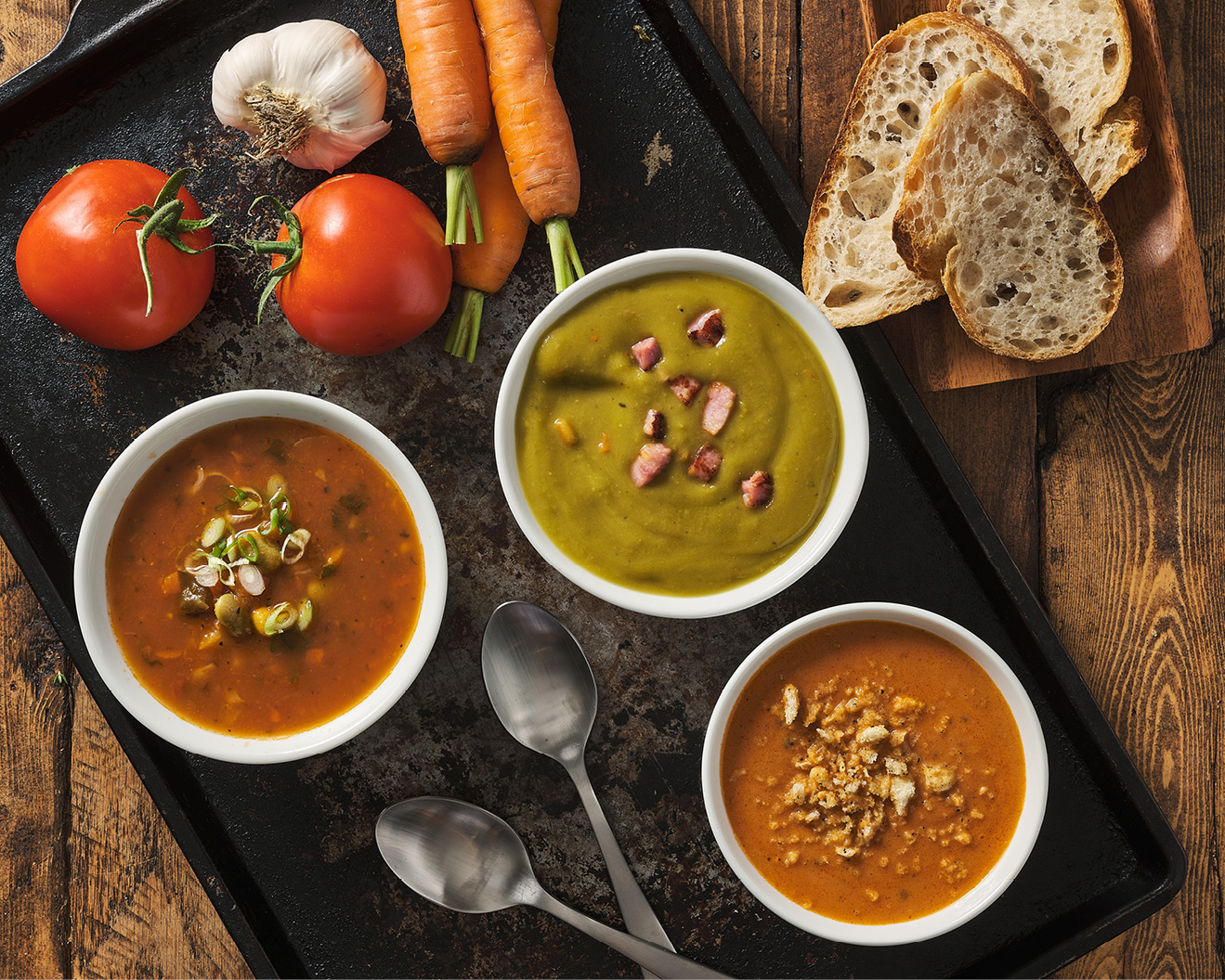 Bowls of split pea, tomato basil, and farmer's market vegetable soup