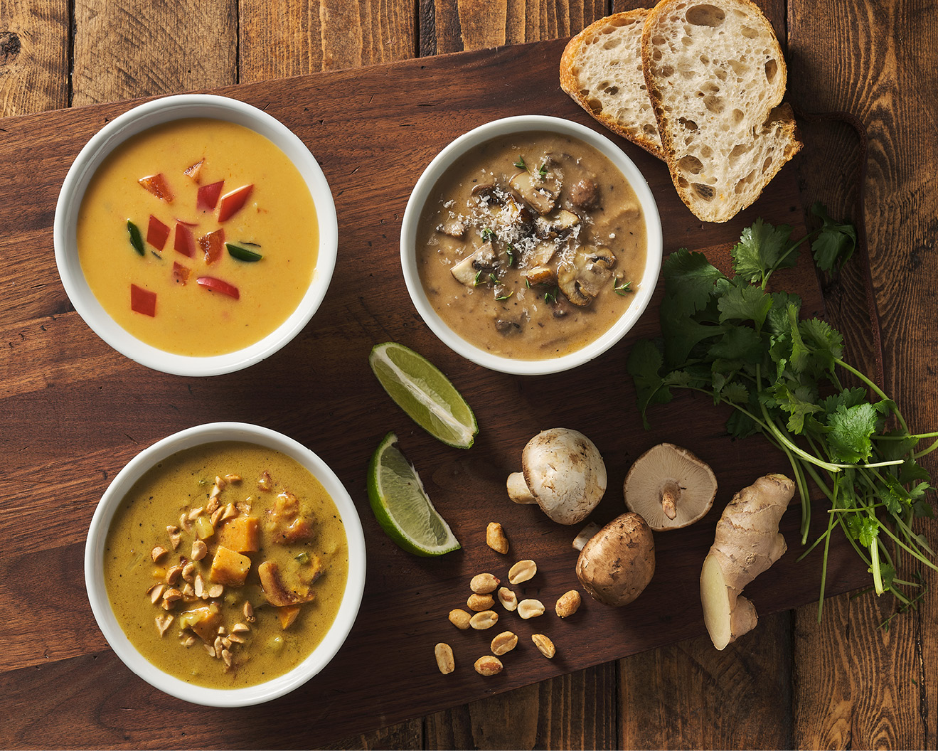 Bowls of chicken coconut curry, French mushroom bisque, and African peanut soup