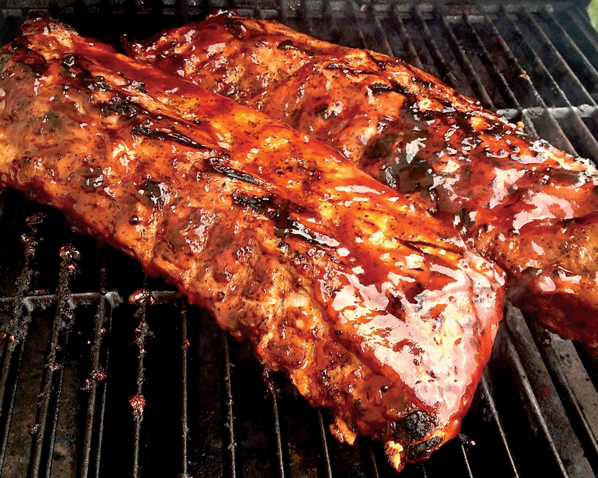 bbq ribs on the grill with sauce