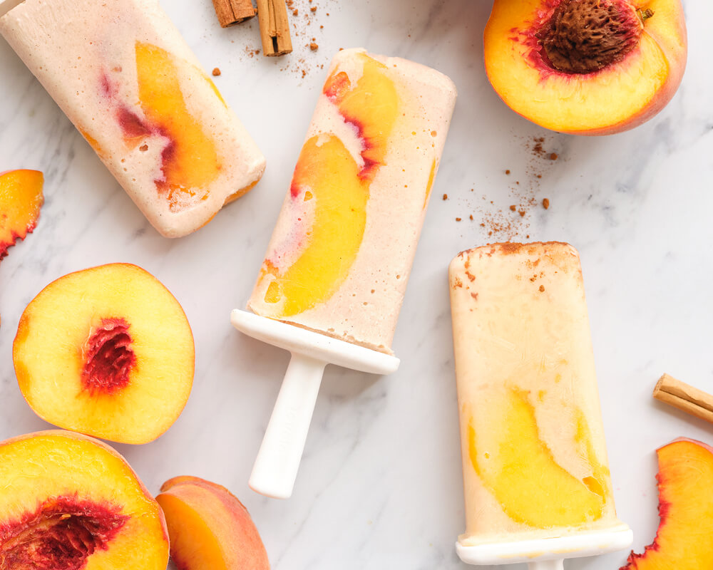 peach horchata popsicles with peach halves and cinnamon