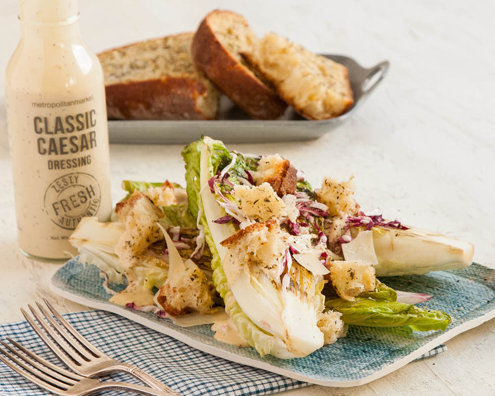 grilled caesar salad with dressing and garlic bread