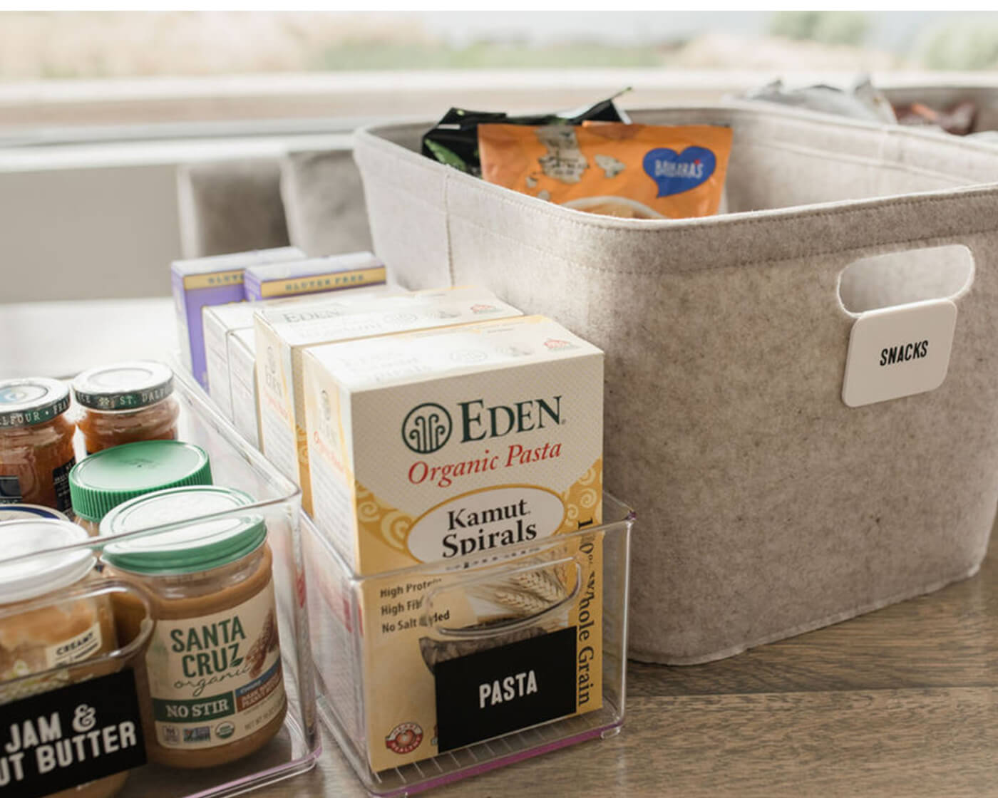 Bins of organized pantry essentials.