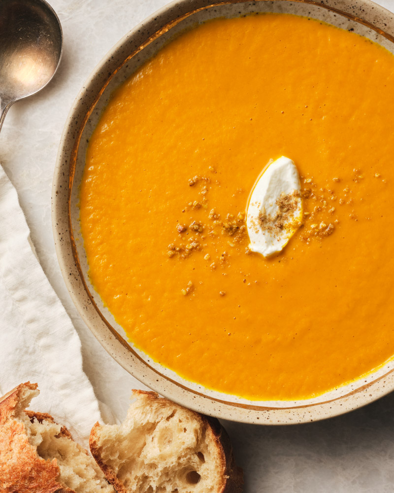 bowl of carrot soup with bread