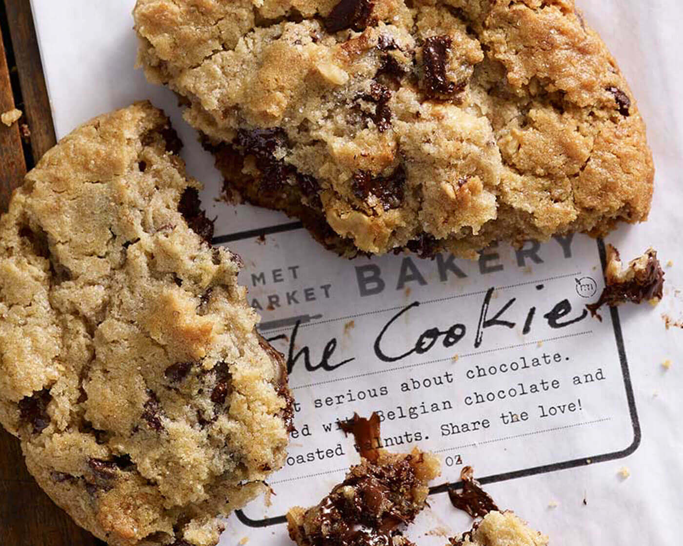 a large chocolate chip cookie broken in three pieces