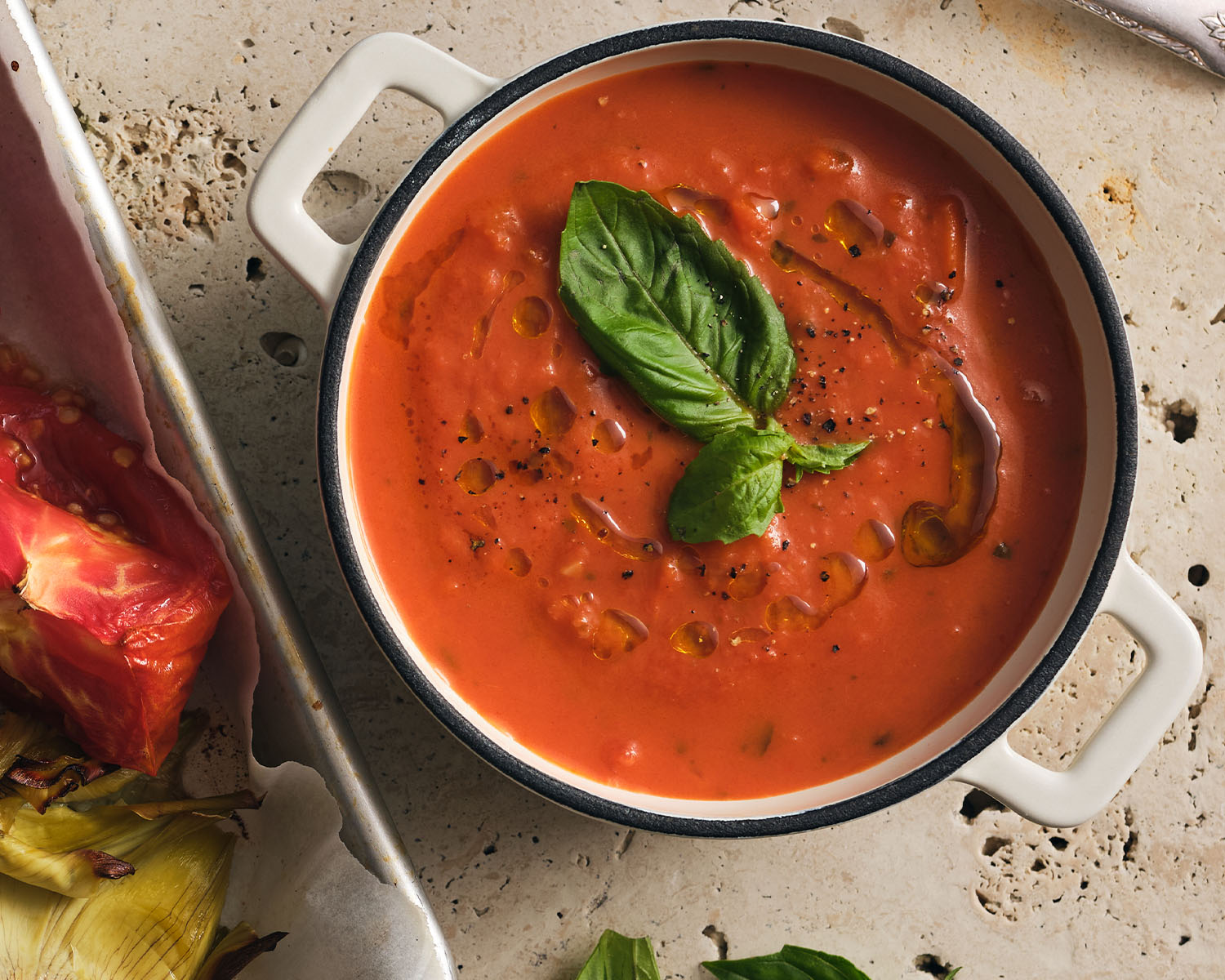 Rich red soup topped with fresh basil.