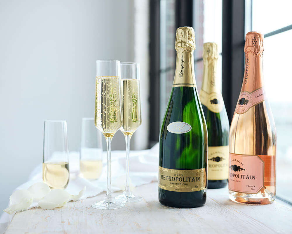 Champagne bottles and glasses on a table with a white linen tablecloth