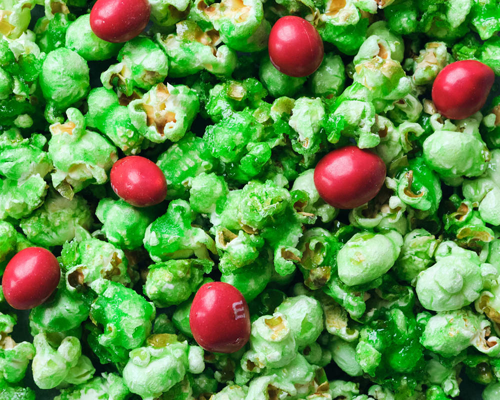 Green popcorn with red candy.