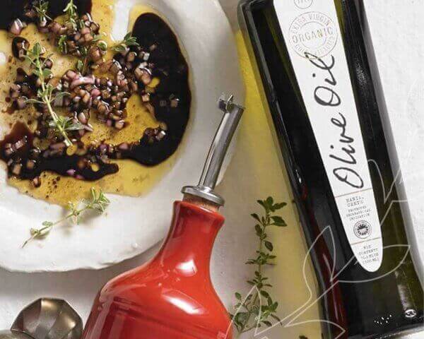 Bottle of Metropolitan Market olive oil with a dish for dipping.