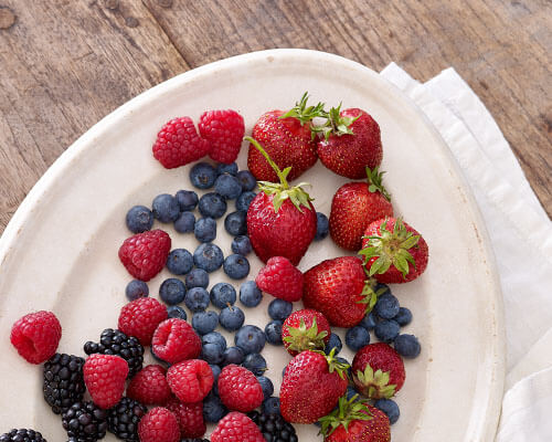 strawberries, blueberries, raspberries and blackberries on a plate