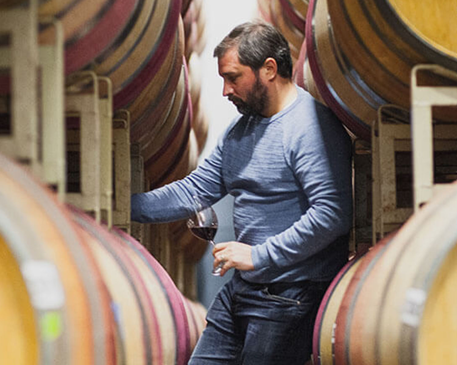 Jason Gorski checking on barrels of wine.