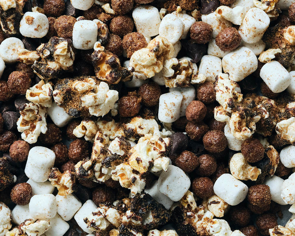 Popcorn mixed with cocopuffs, marshmallows, and chocolate.