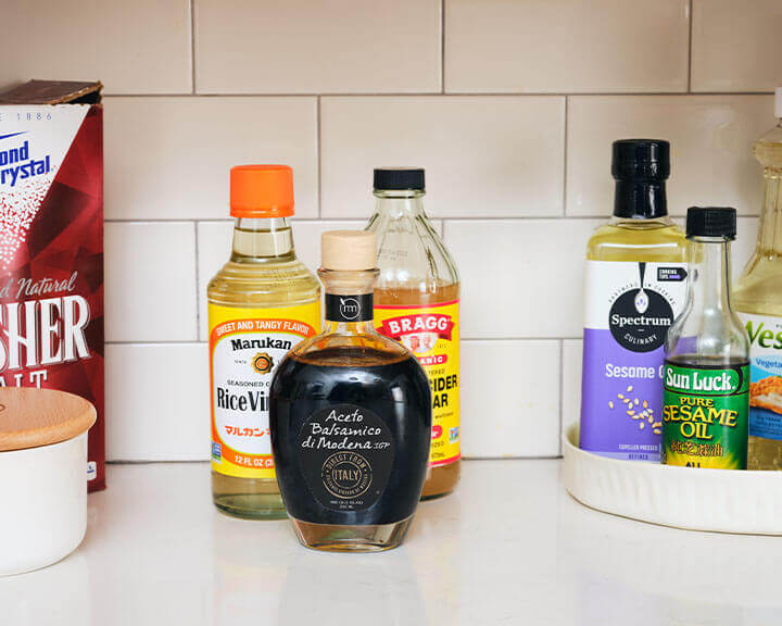 Various vinegars on a pantry shelf.