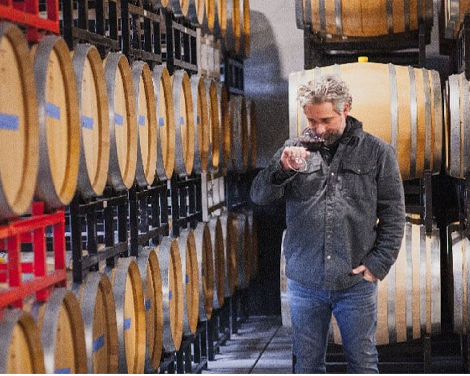 Chris Gorman smelling wine in a cellar