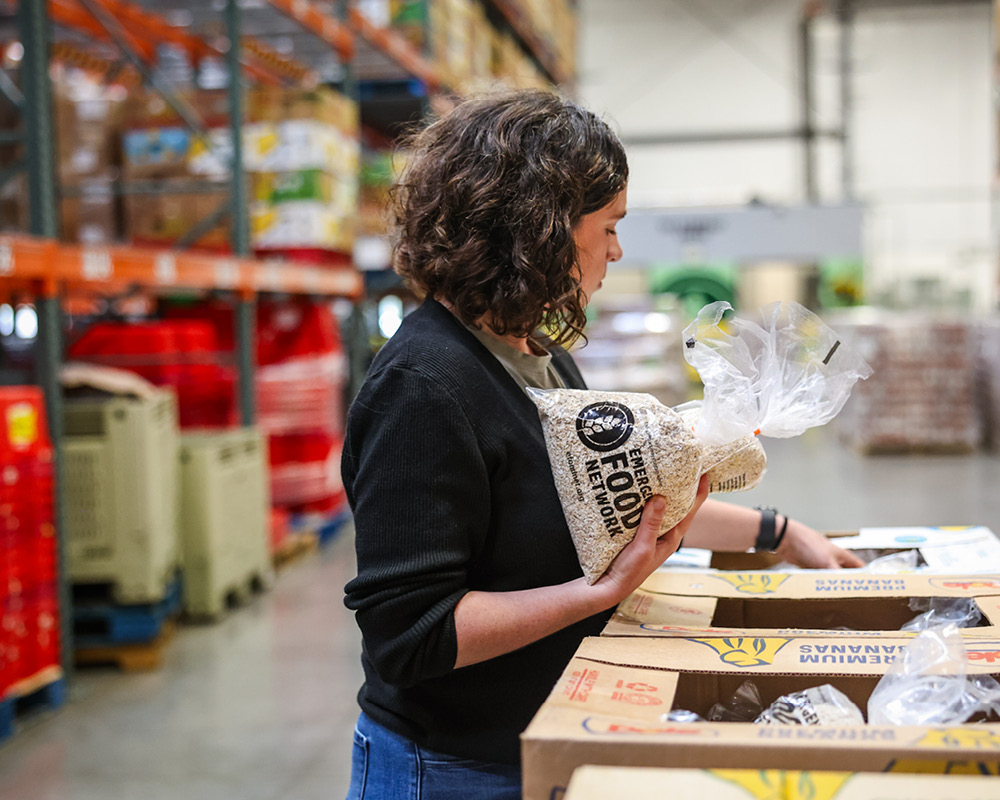 Woman packaging food in warehouse