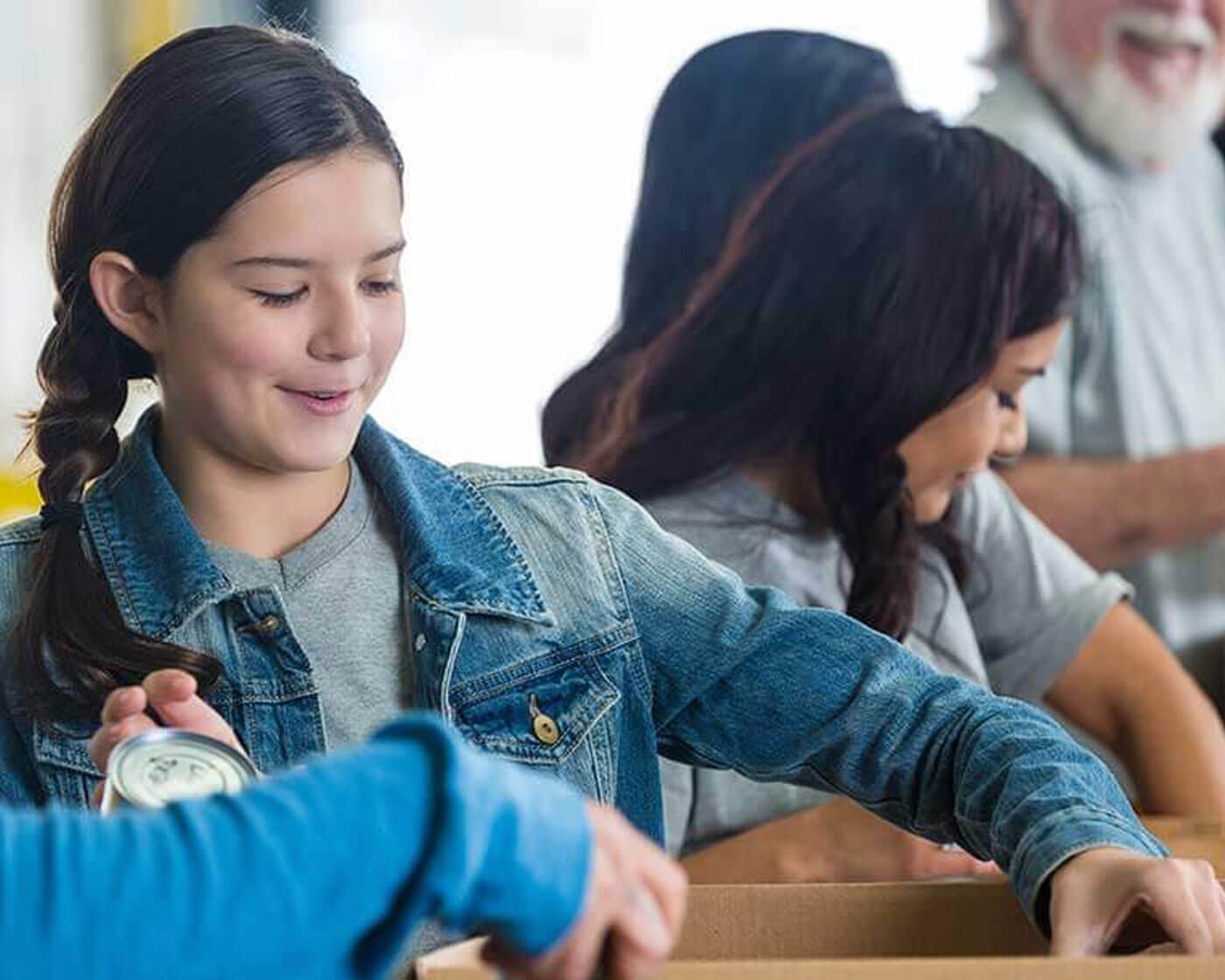 People filling community food pantry boxes