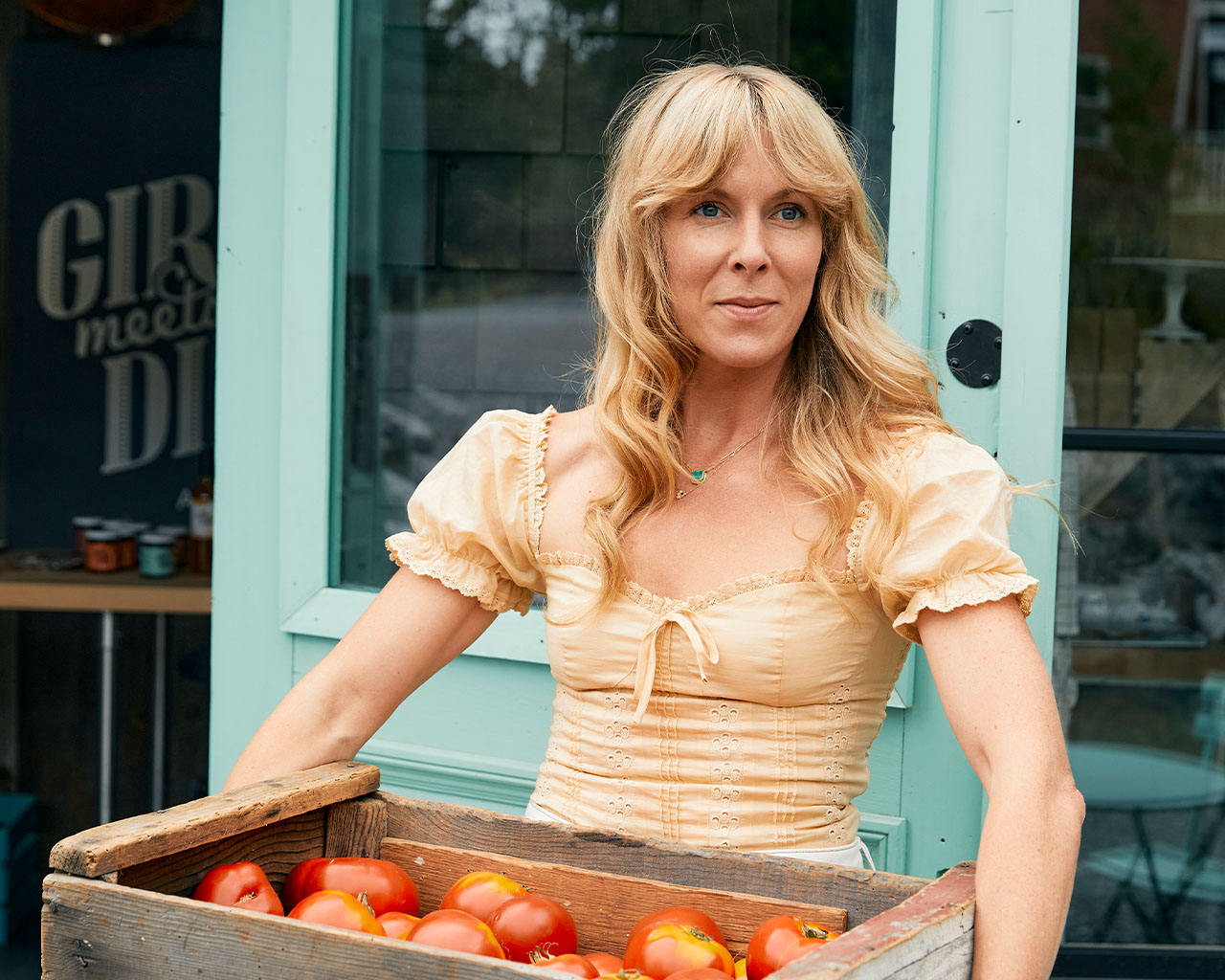 Audra Lawlor holding a wooden box of produce