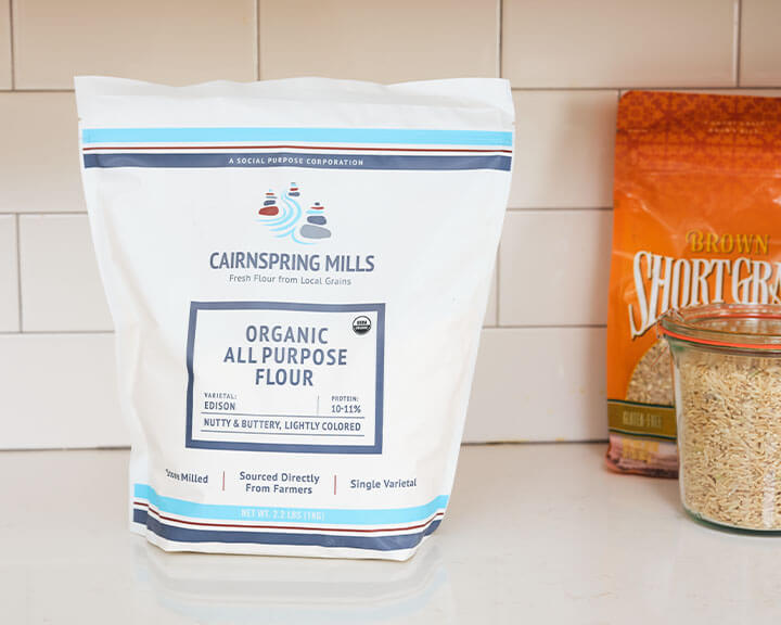 Bag of flour on a pantry shelf.