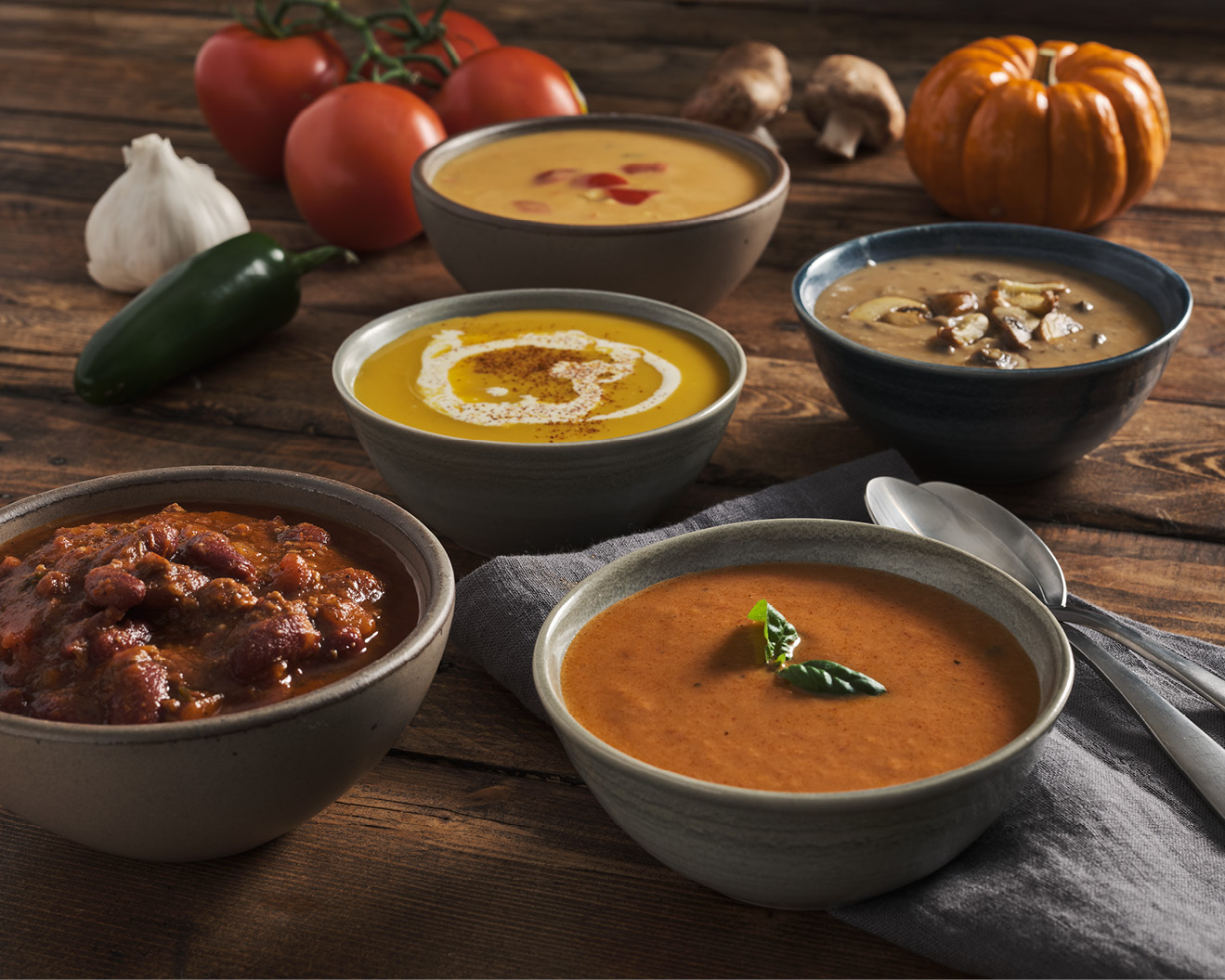 Five bowls of soup on a table