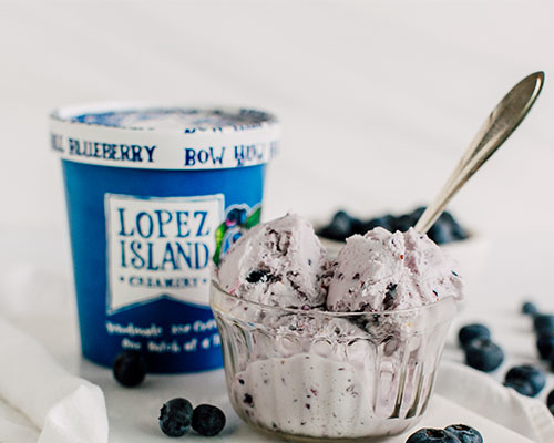 lopez island blueberry ice cream in a bowl and pint container