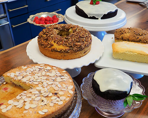 Table filled with baked goods including an almond cake.