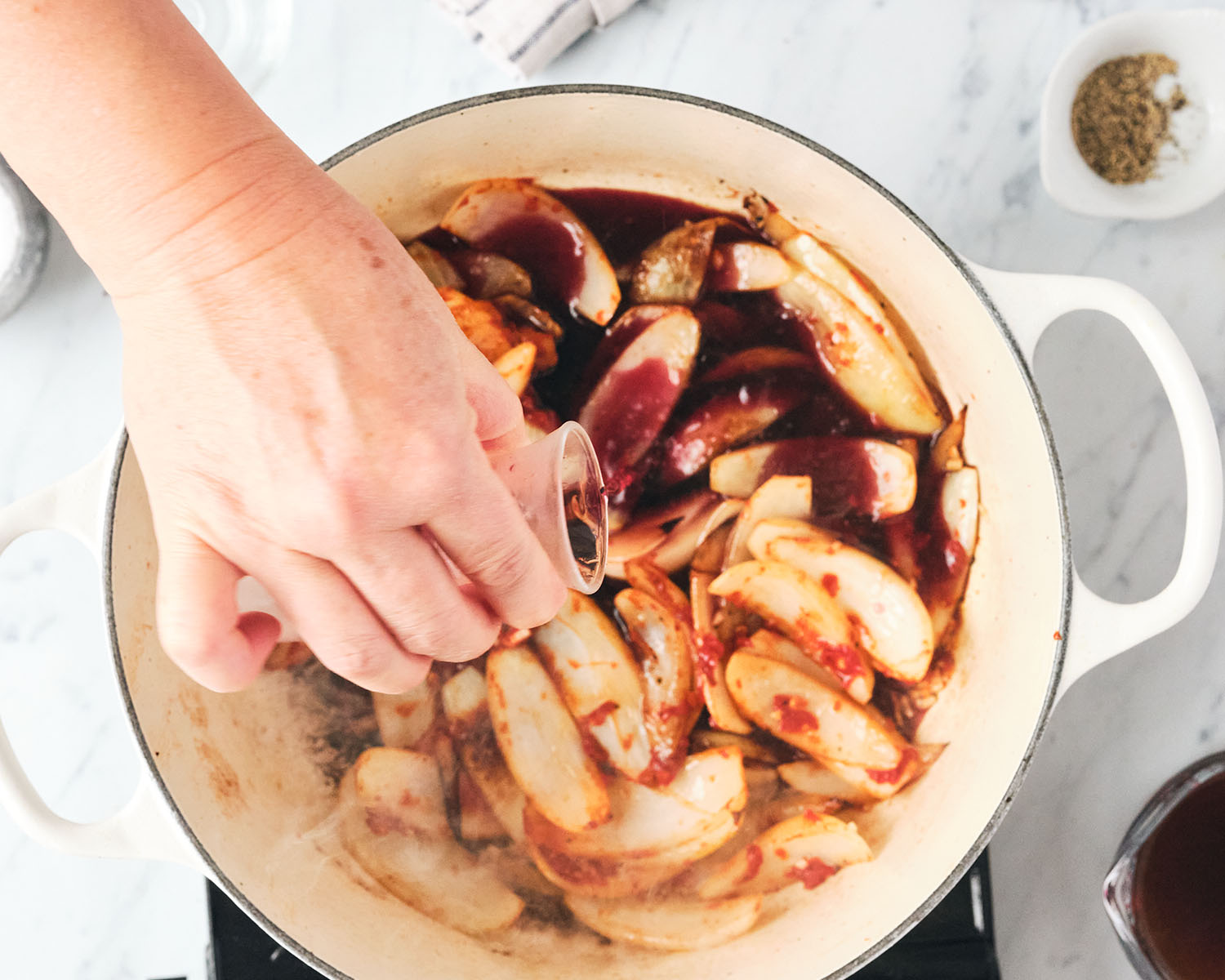 Wine being added to deglaze the pan