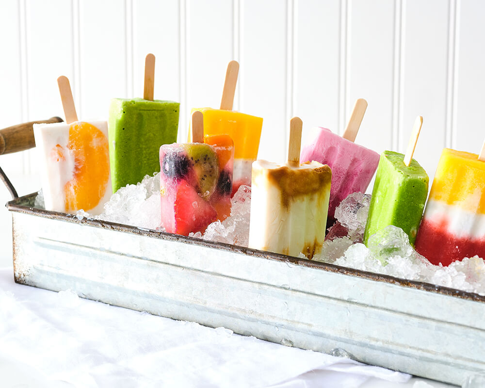 popsicles upside down in a tray with ice