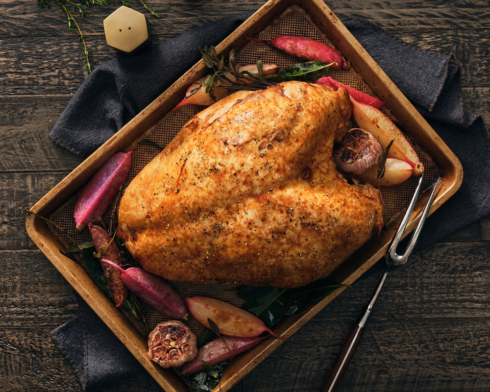 Roasted turkey in pan with wings and legs removed