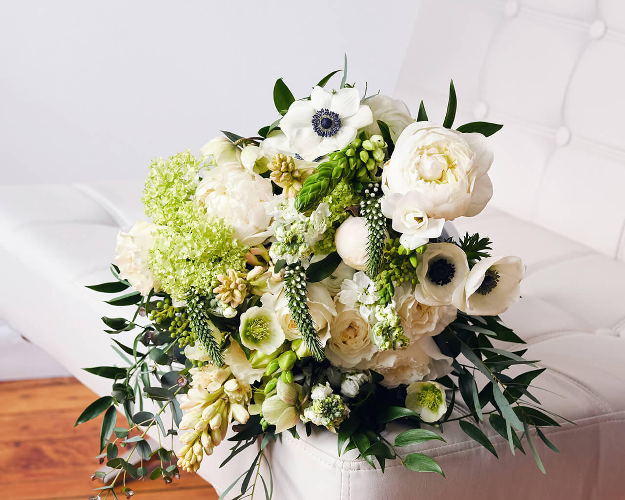 White and green bouquet in a white chair