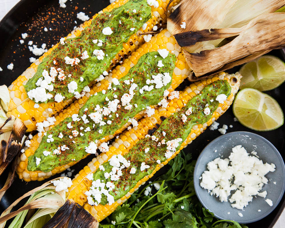 grilled corn on the cob with cotija cheese and guacamole