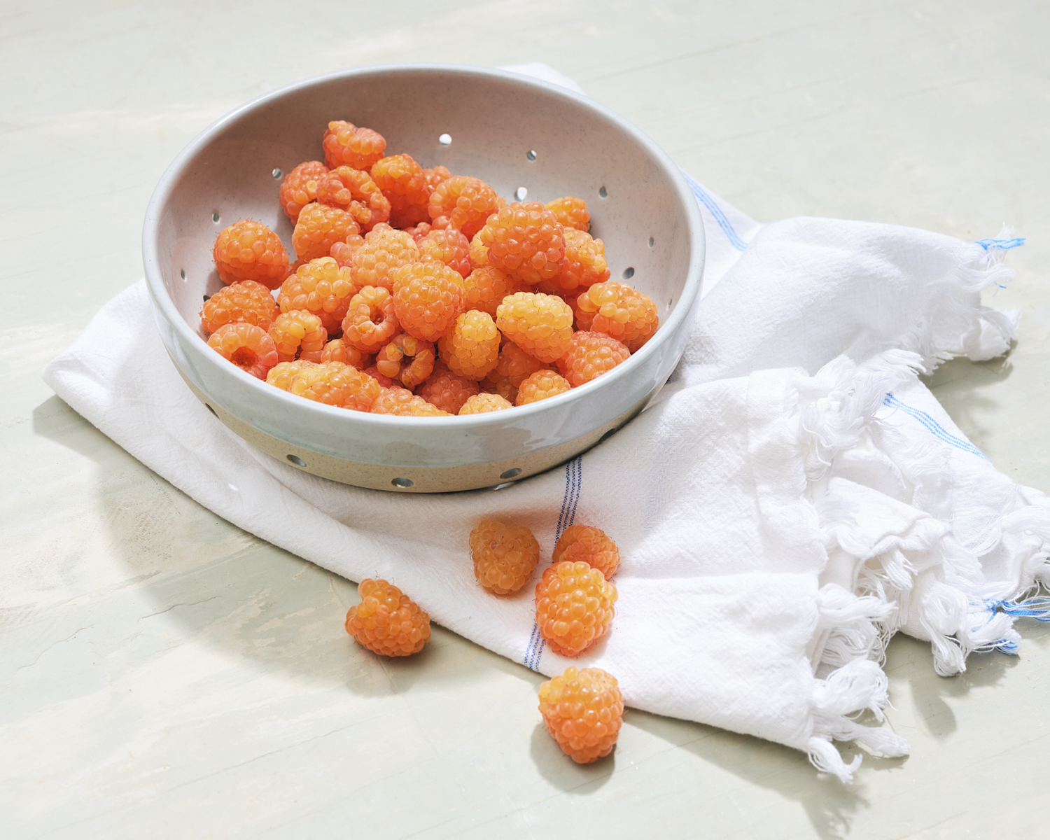 bowl of golden raspberries