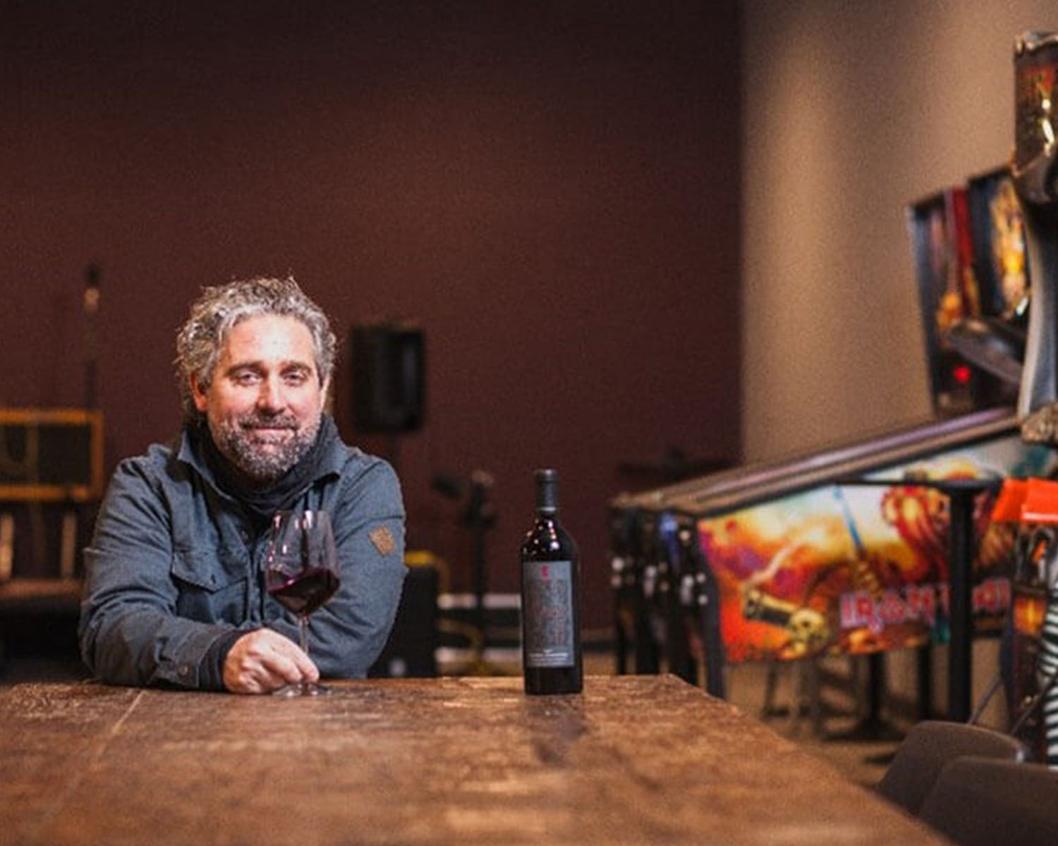 Chris Gorman sitting at a table with a glass of wine