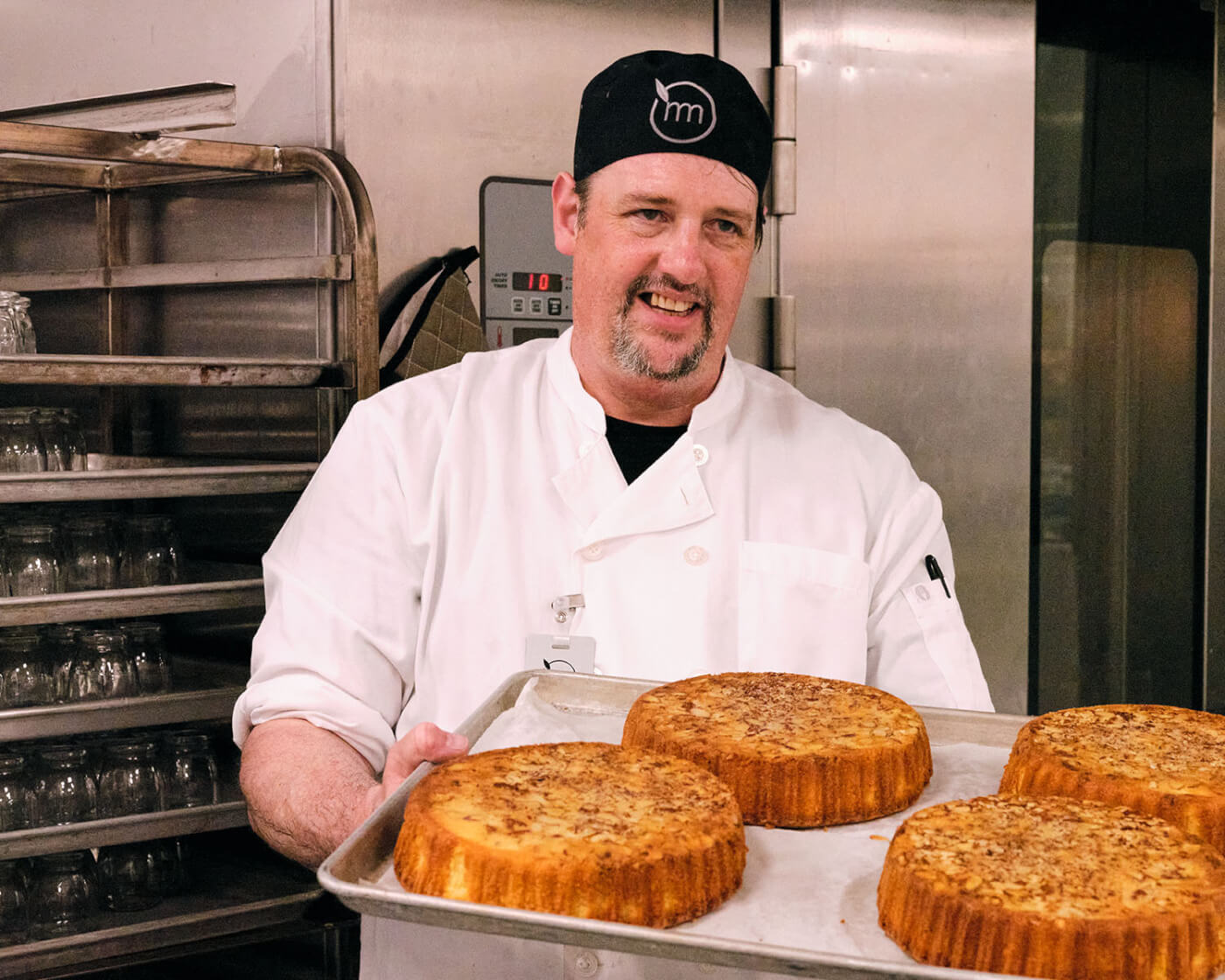 baker with prepared almond cakes ready to go