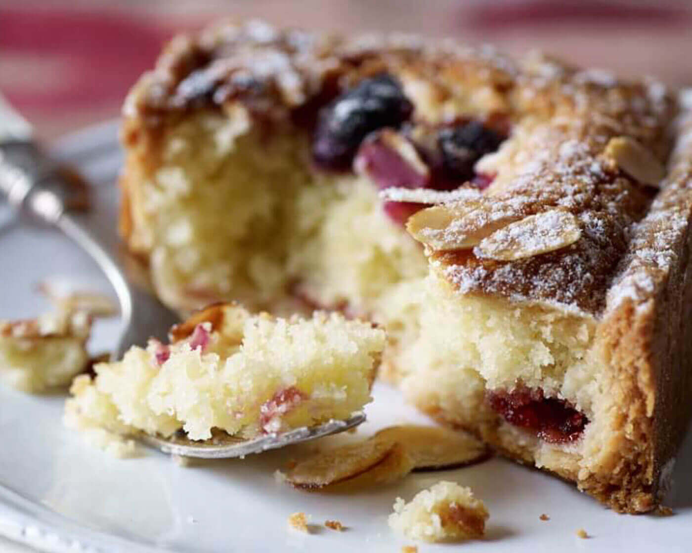 Close up image of a bakewell tart with a fork.