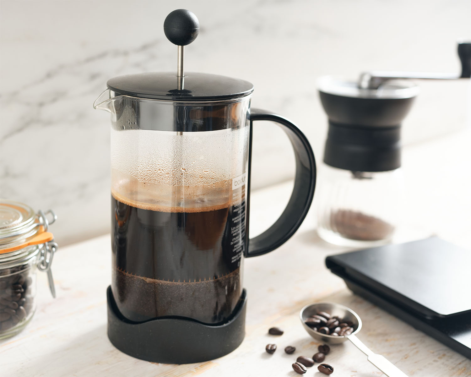 French press coffee maker half filled with coffee