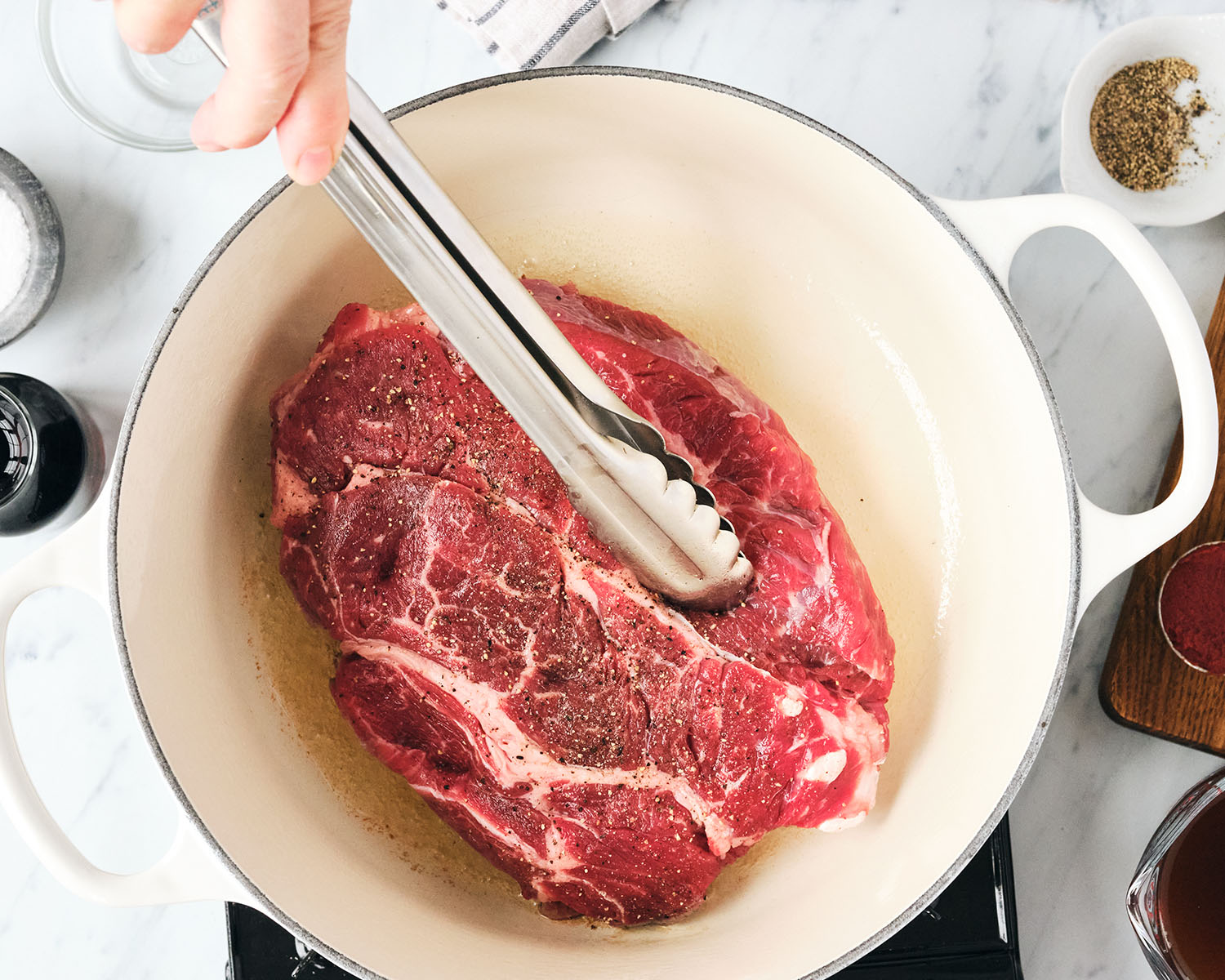 Roast being seared in a hot pan