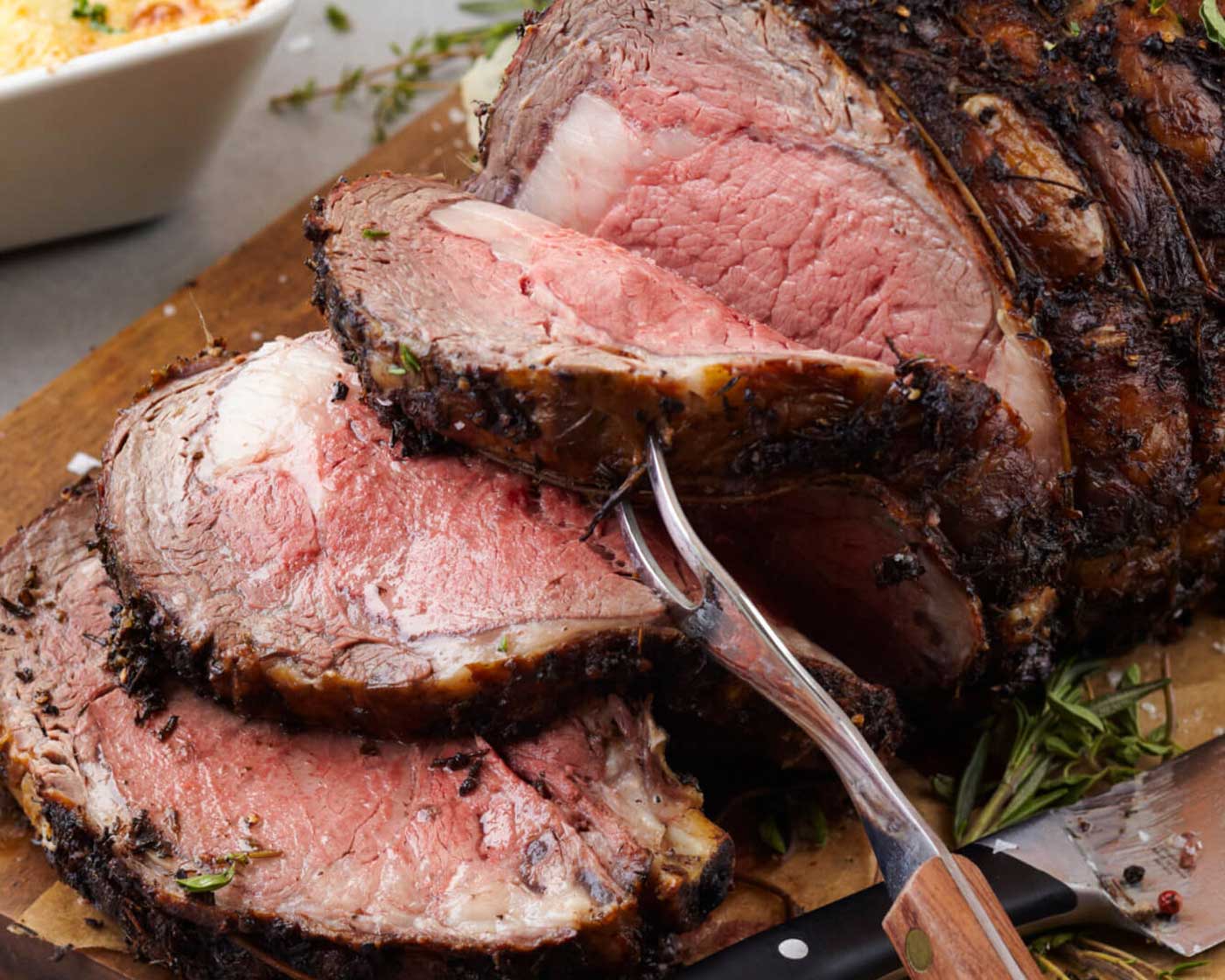 Sliced prime rib roast on a cutting board