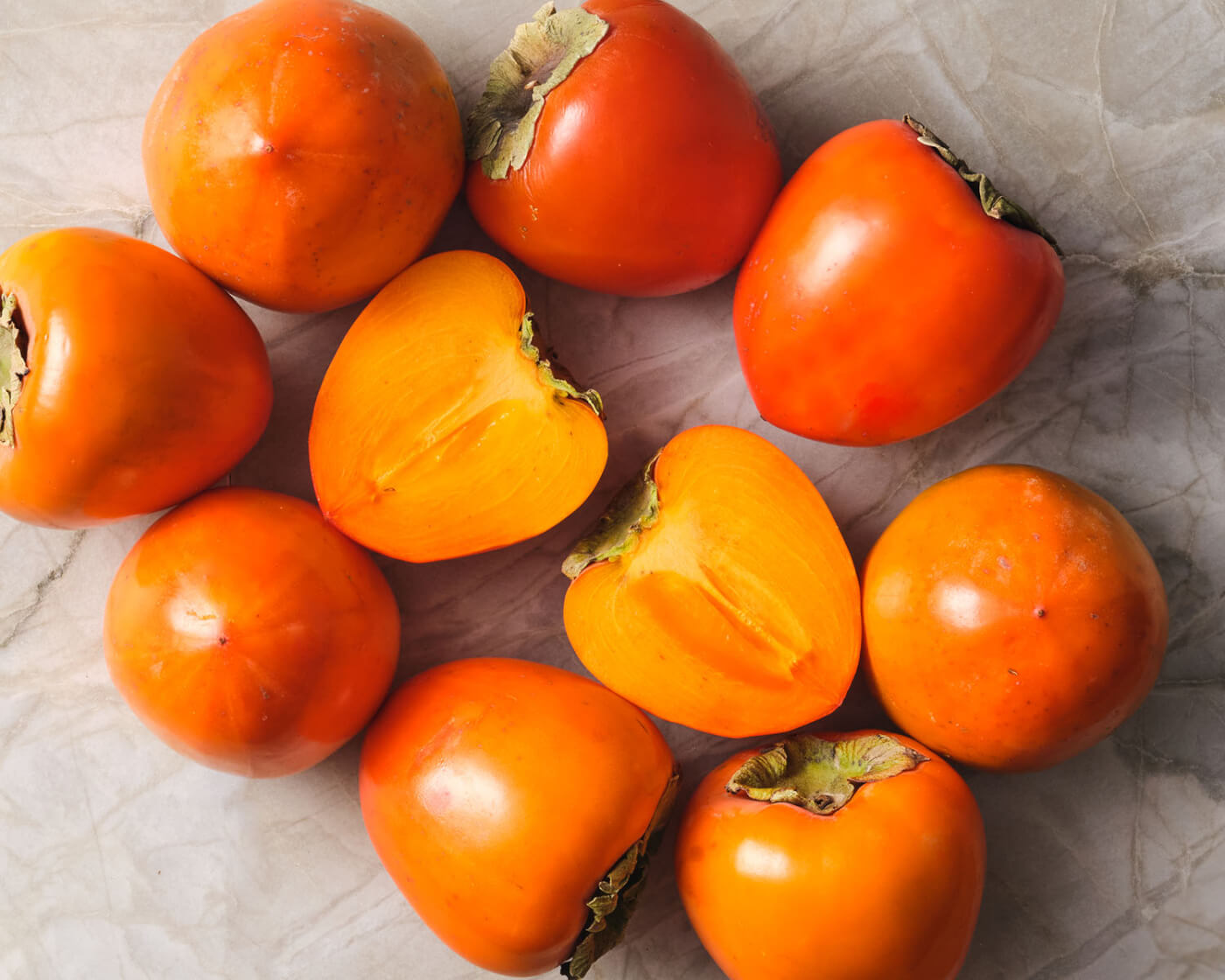 persimmons on marble background