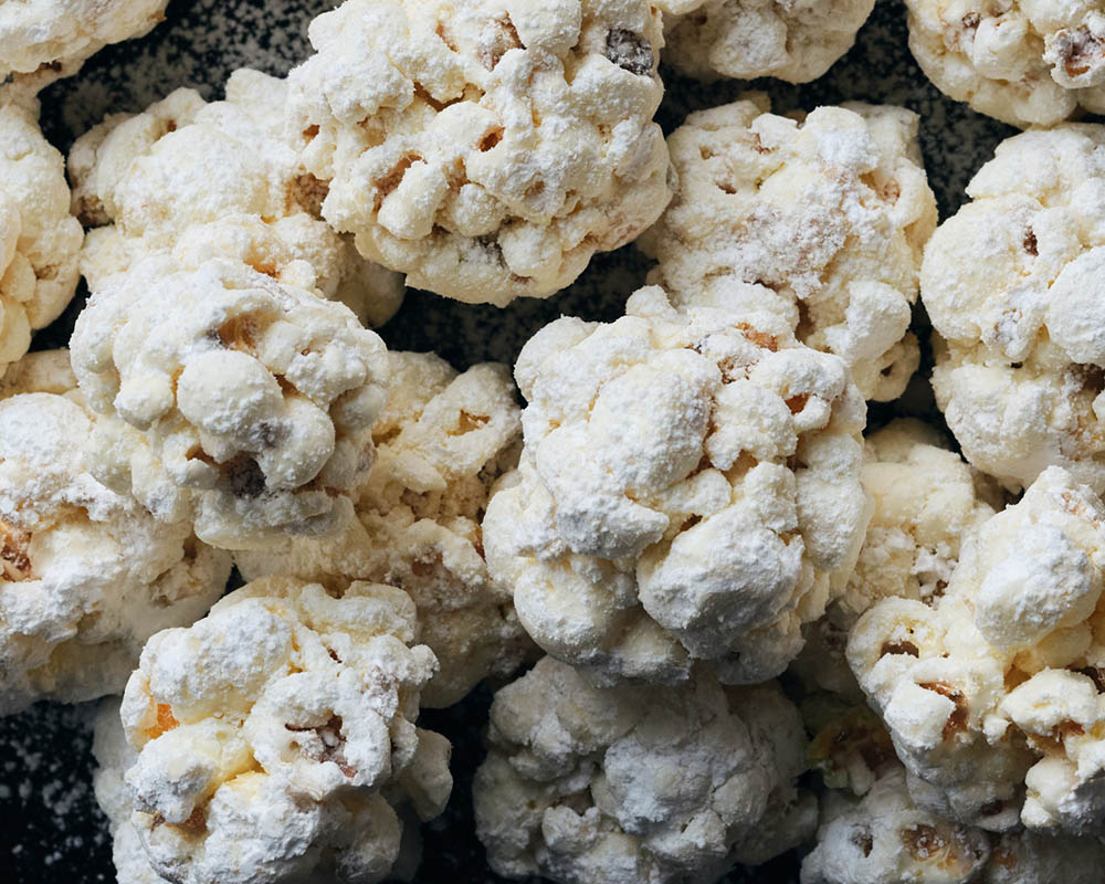 Popcorn balls coated in powdered sugar.