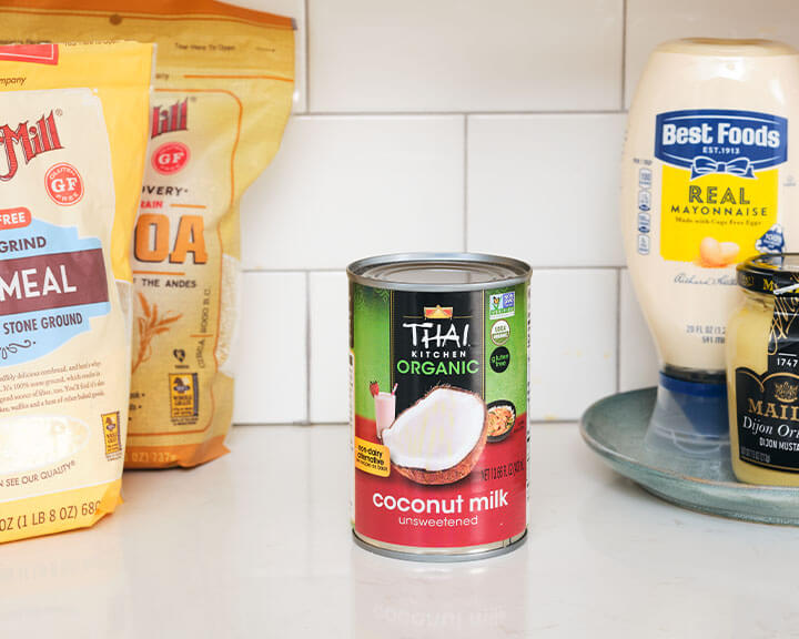 Can of coconut milk on a pantry shelf.