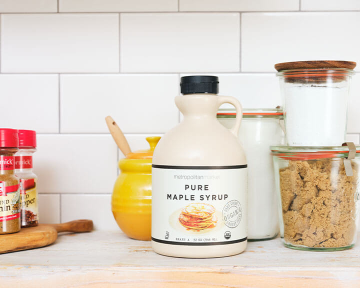 Various sugars and sweeteners on a pantry shelf.