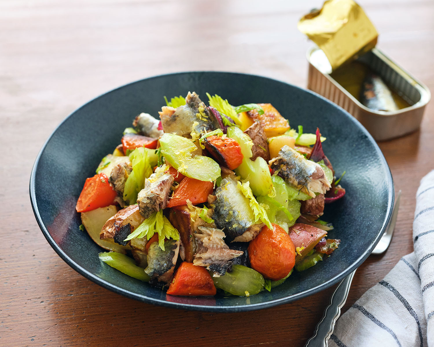 bowl of root salad with sardines