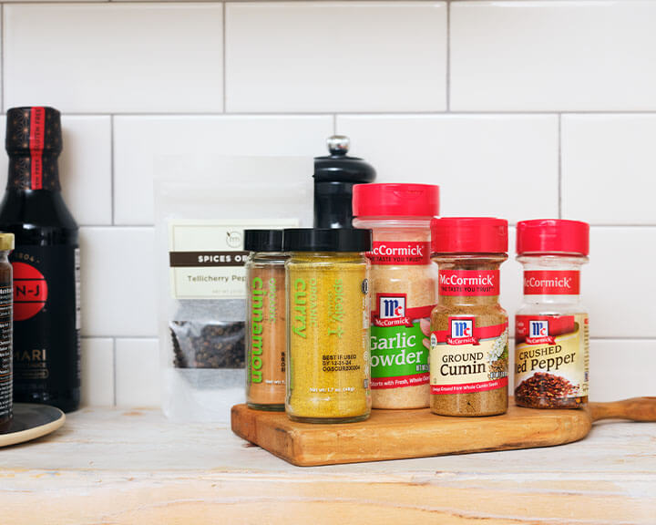 Various spices on a pantry shelf.