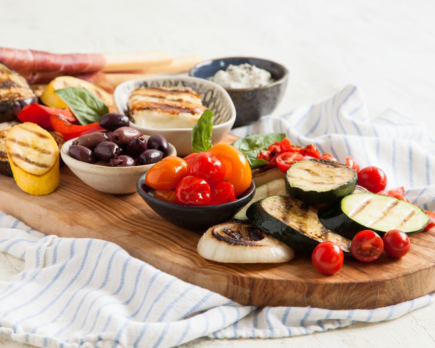 grilled vegetables on a cutting board with a napkin