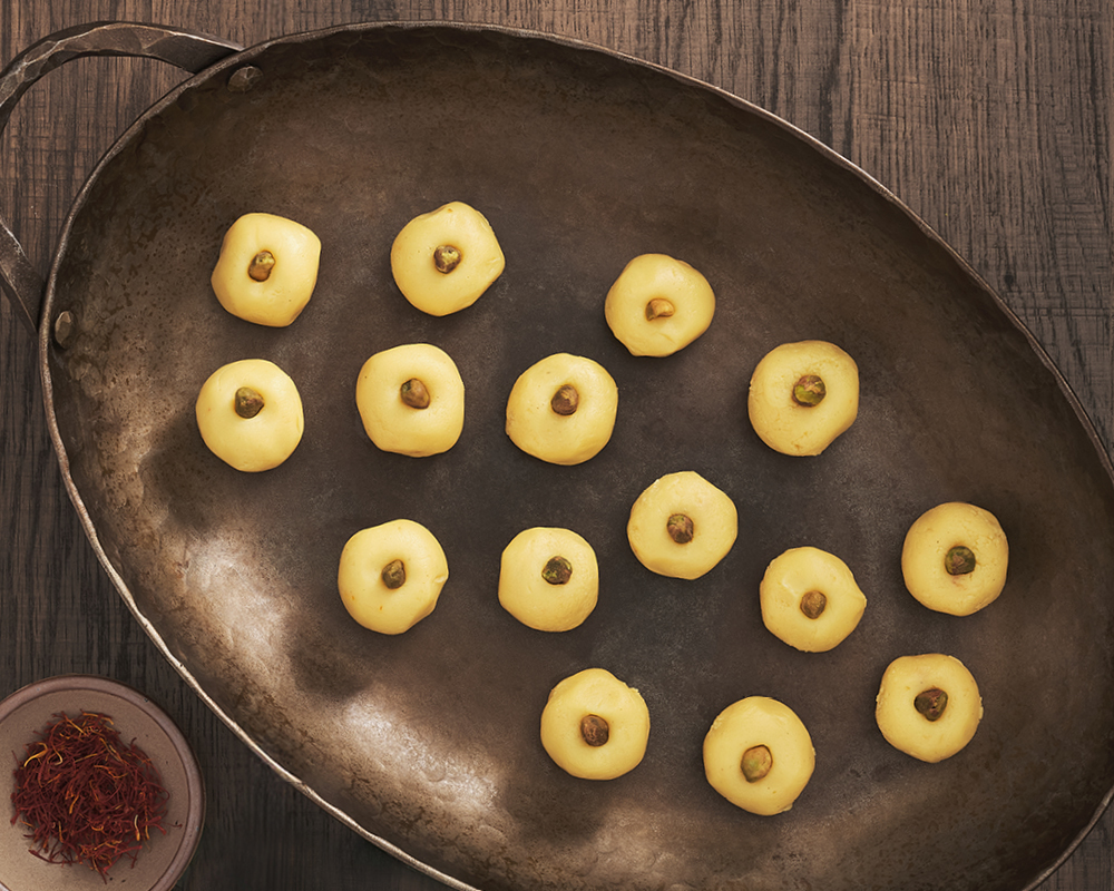 Several bite-sized desserts scattered around a bronze serving tray